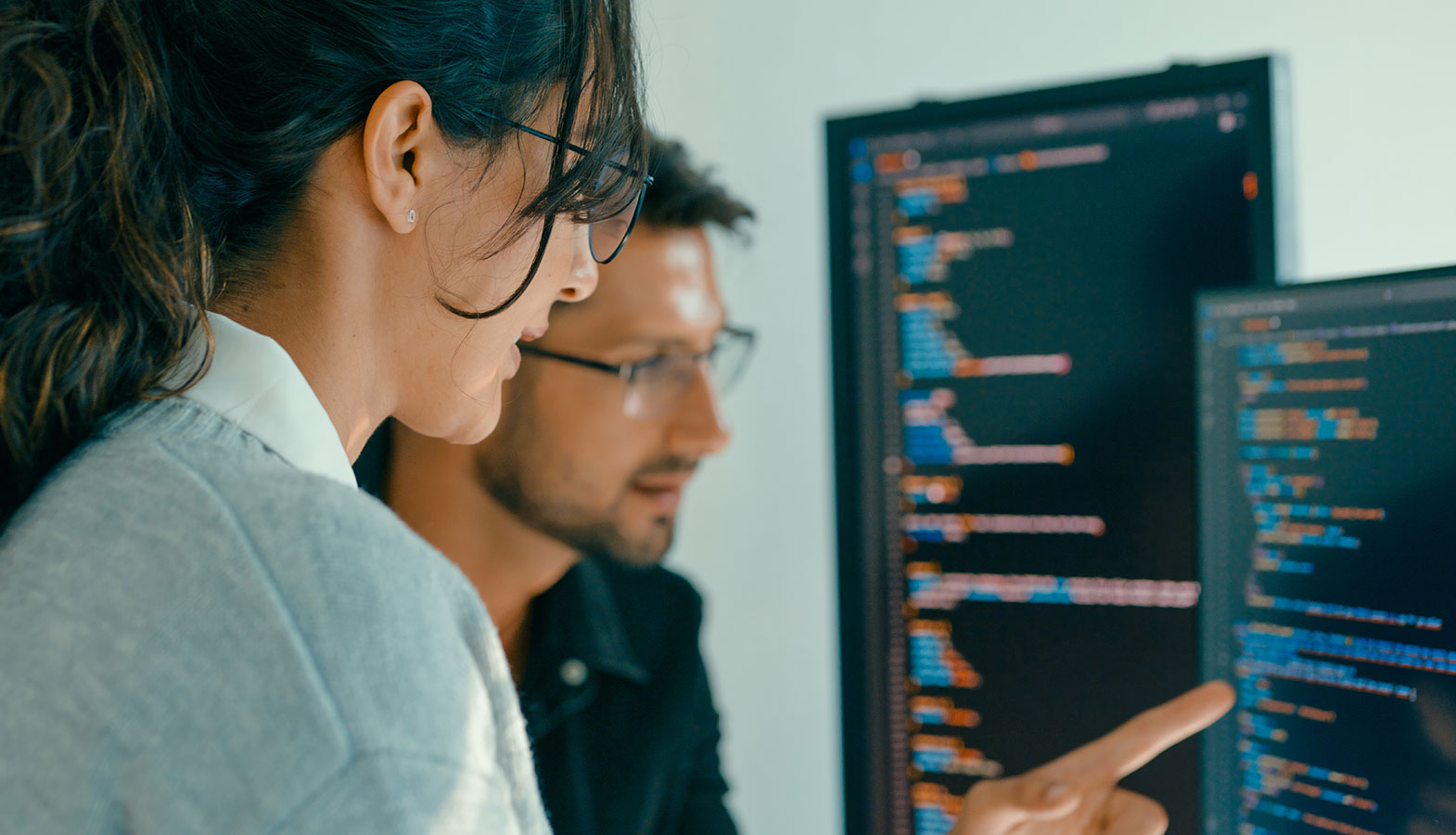 A business professional is intently reviewing an analytics dashboard on a laptop screen, analyzing core web vitals metrics such as largest contentful paint and cumulative layout shift to assess website performance and improve user experience. The dashboard displays various graphs and data points that reflect the site's performance and user interactions, aiding site owners in optimizing their web pages for better search rankings.