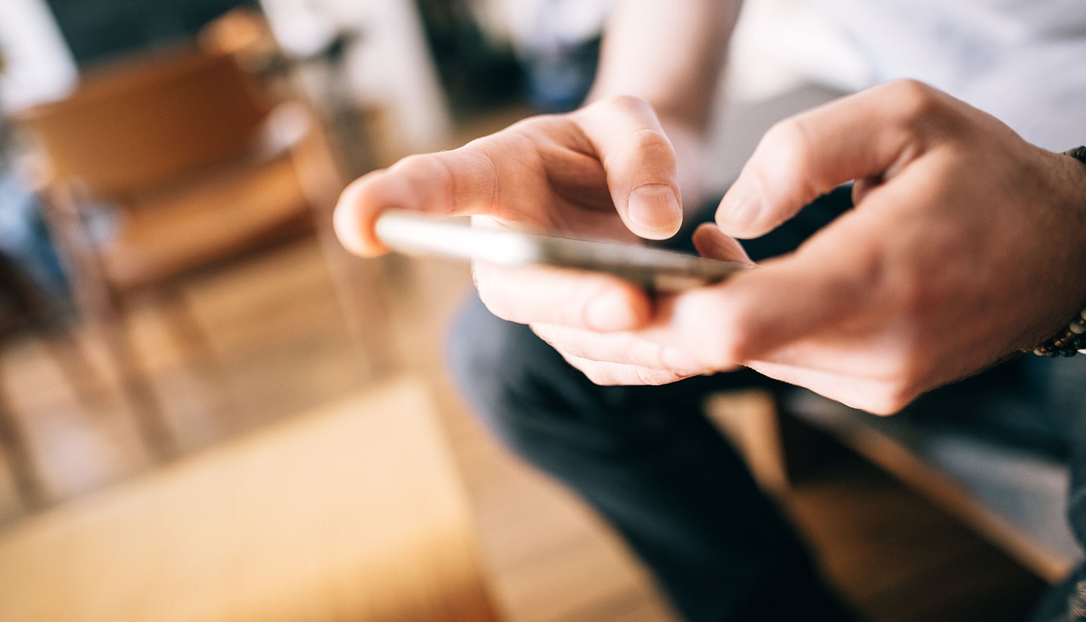 An individual is tapping a button on a mobile phone screen, demonstrating user interaction with a web page. This action highlights the importance of measuring responsiveness and optimizing input delays to improve user satisfaction and ensure a good INP score.